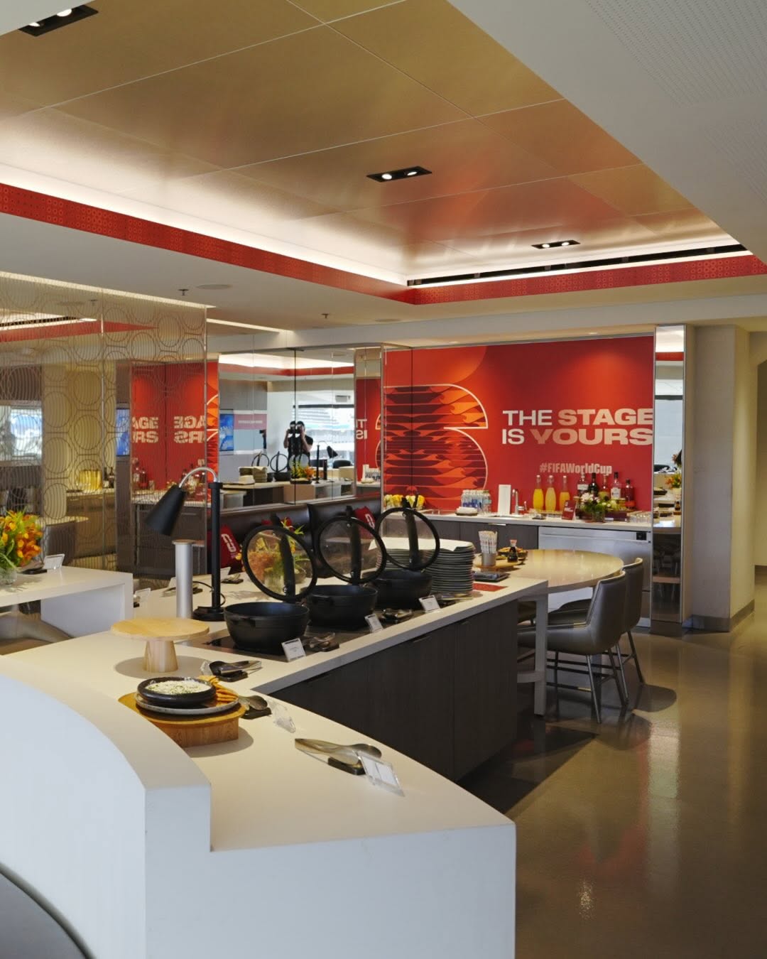 FIFA World Cup hospitality buffet and lounge with red environmental graphics