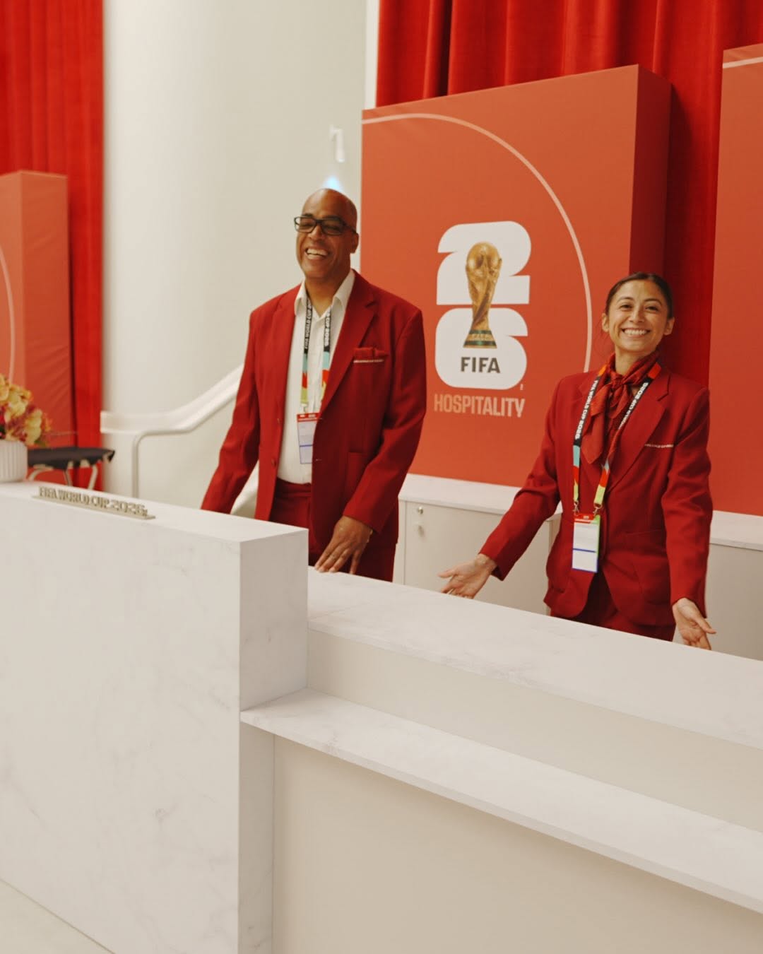 Hospitality team welcoming guests at a branded FIFA reception desk